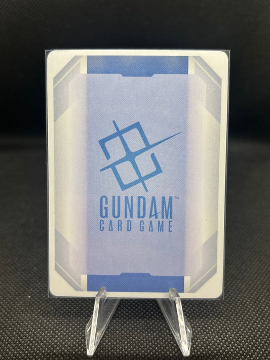 Gundam card game packaging with clear lid on a dark textured background