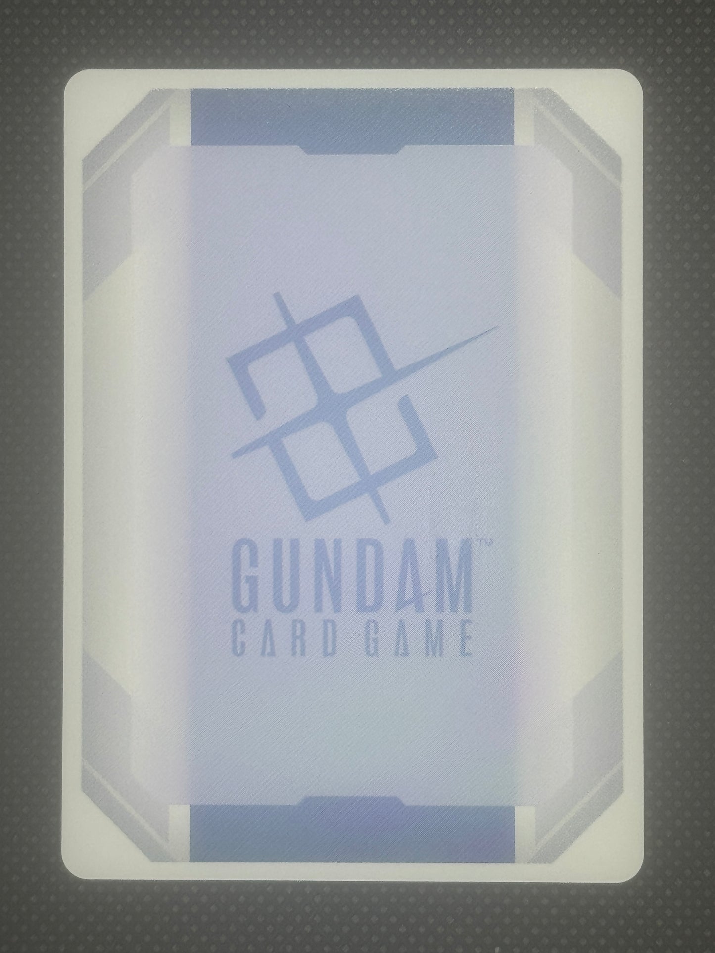 Card game box with 'Gundam' branding on a textured gray background