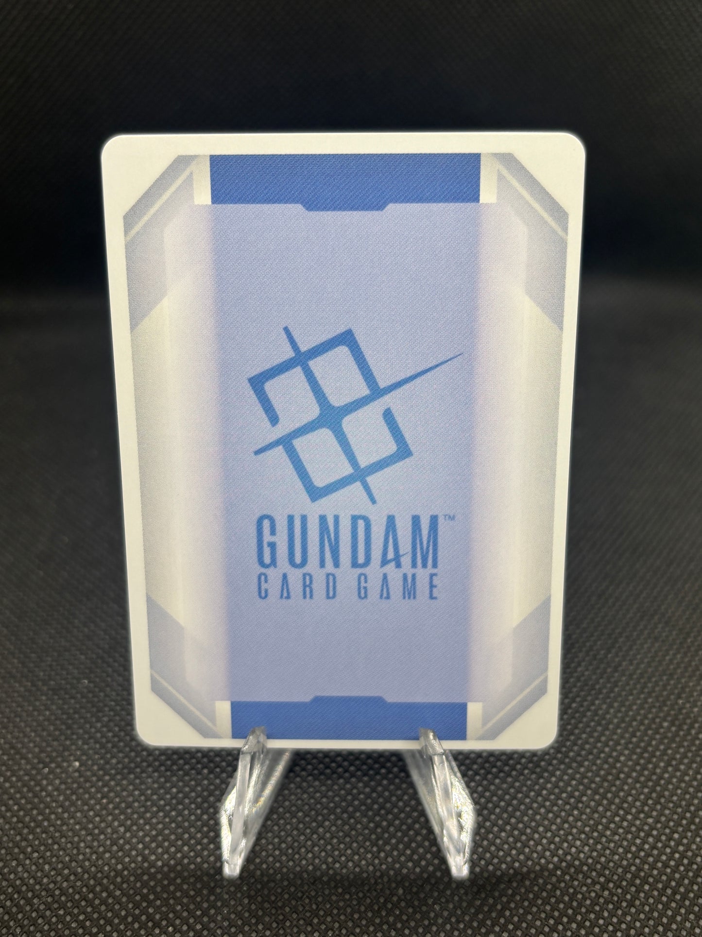 Card holder with 'Gundam Card Game' branding on a dark textured background