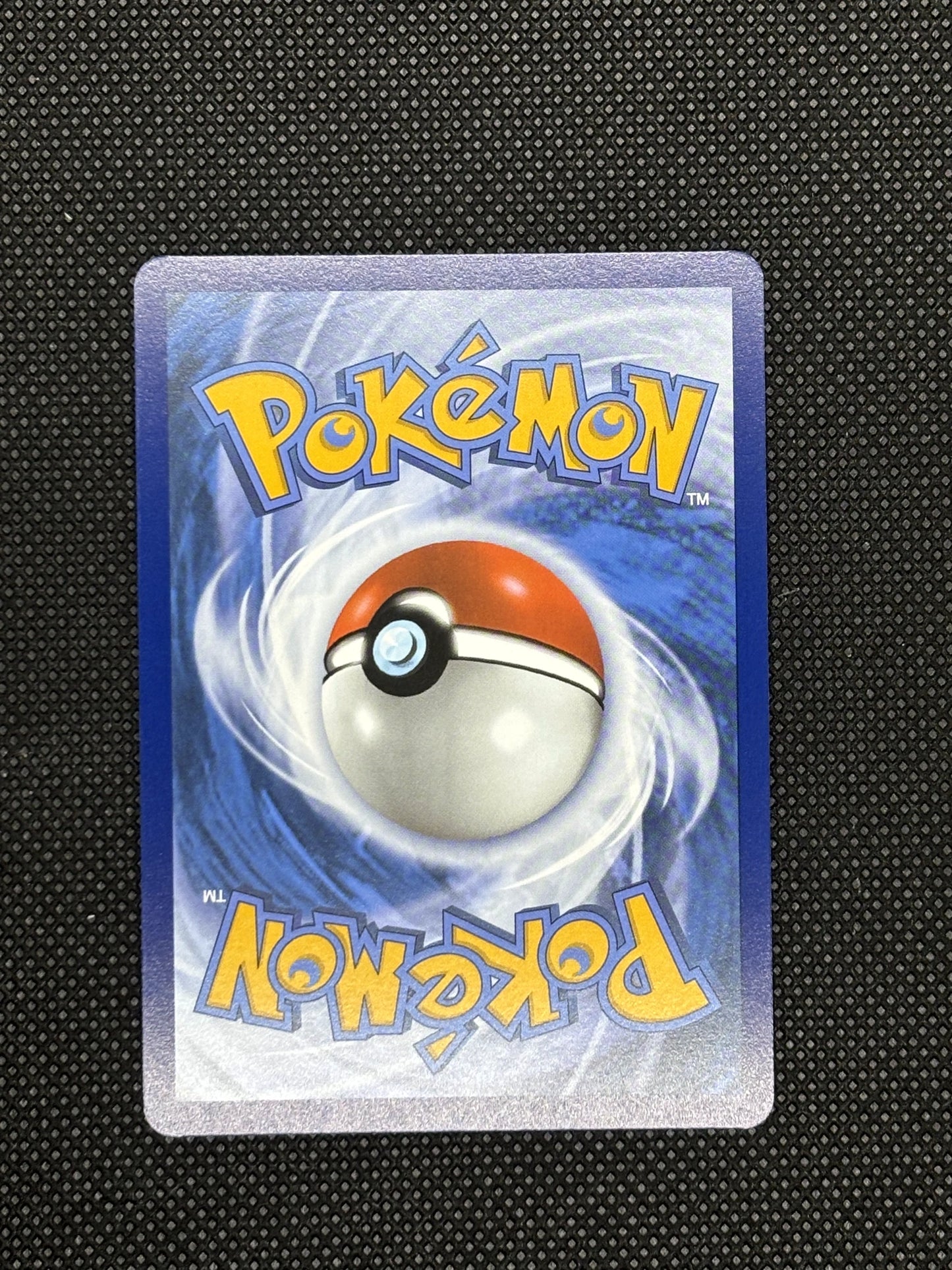 Hearthflame Mask Ogerpon EX from Prismatic Evolutions with a blue background and a pokeball