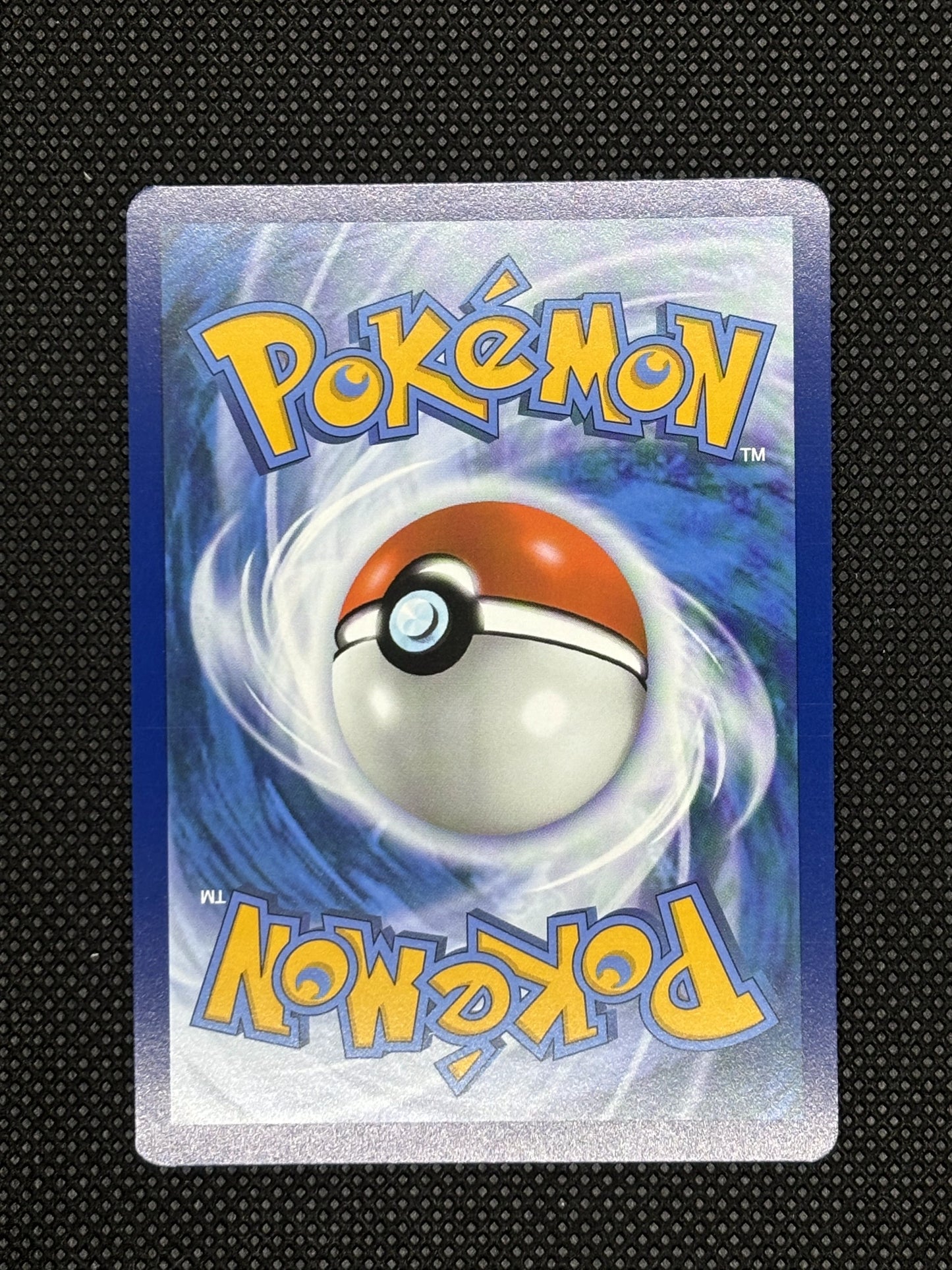 Shaymin from prismatic evolutions backside that is blue and with pokeball.