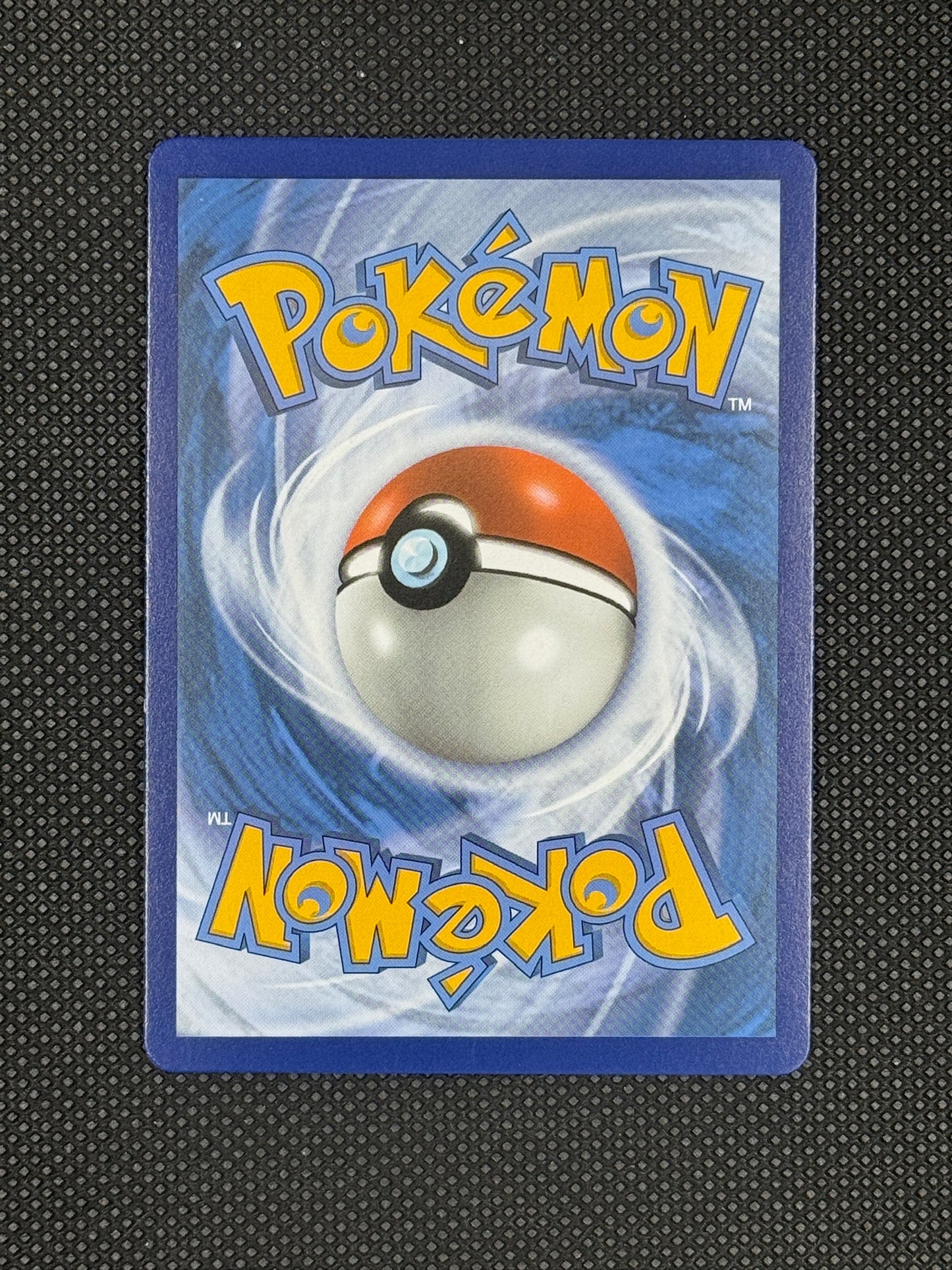 Pokémon trading card with a blue border and Pokéball design on a textured black background