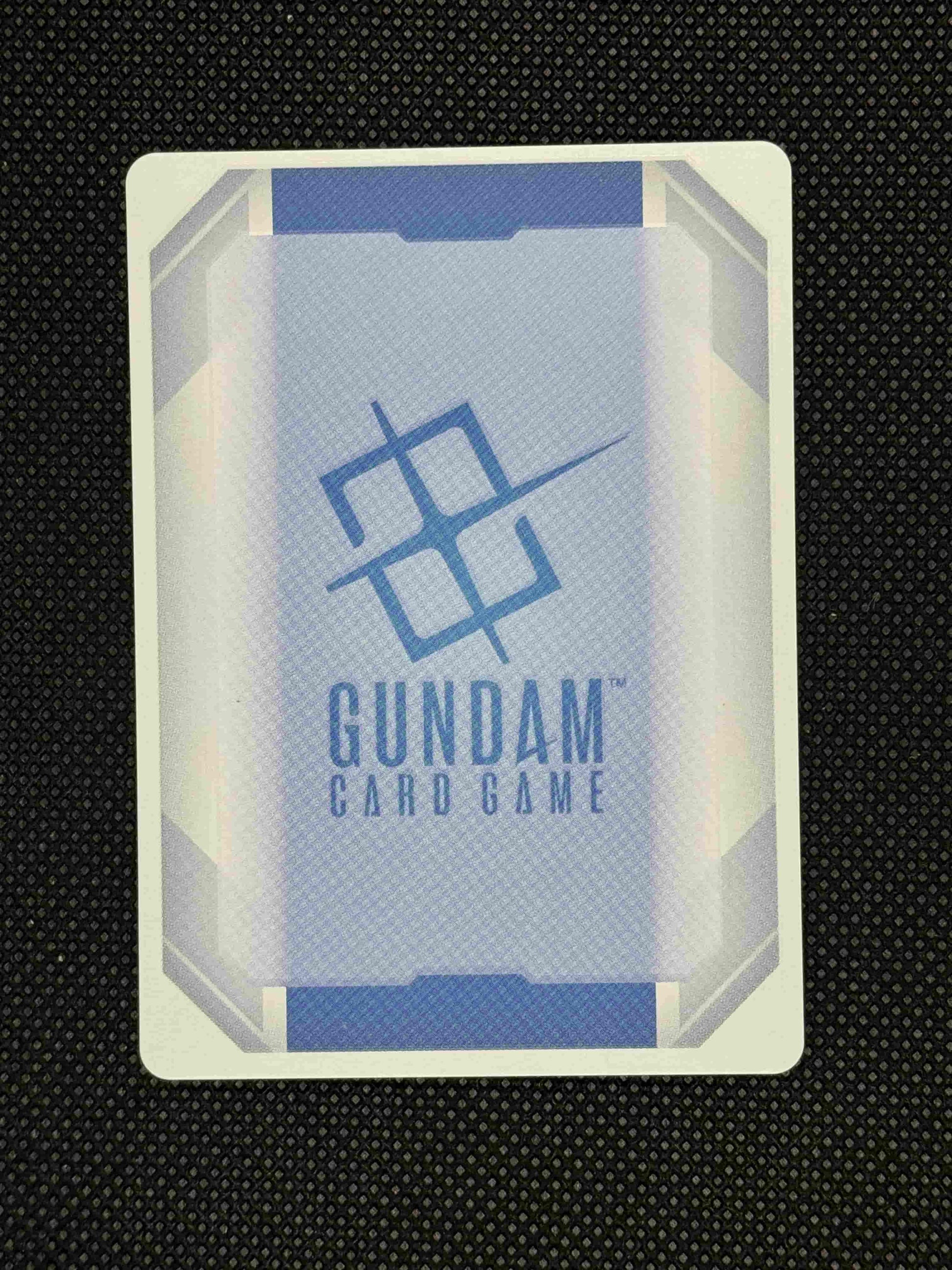 Gundam card game box on a textured black background