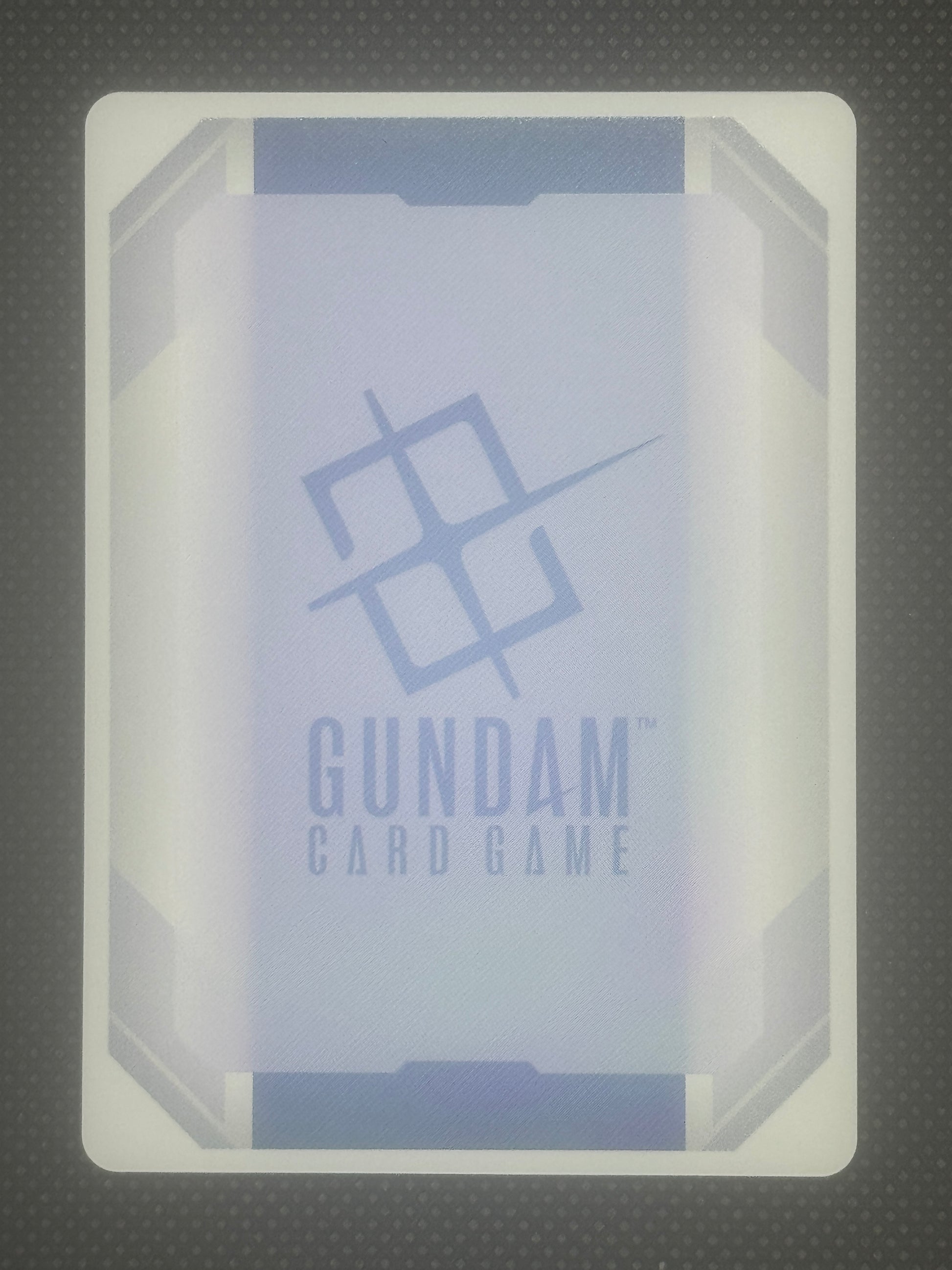 Card game box with 'Gundam' branding on a textured gray background