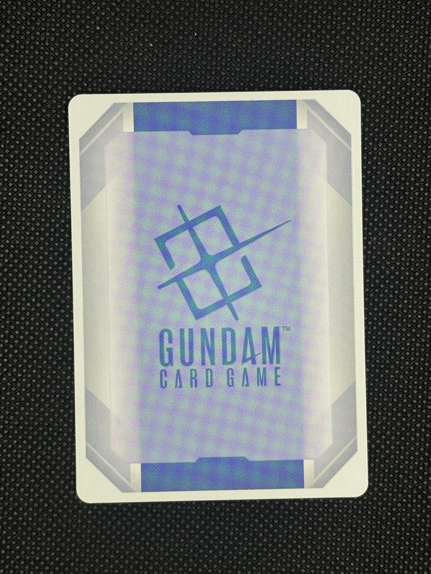 Gundam card game packaging on a textured black background