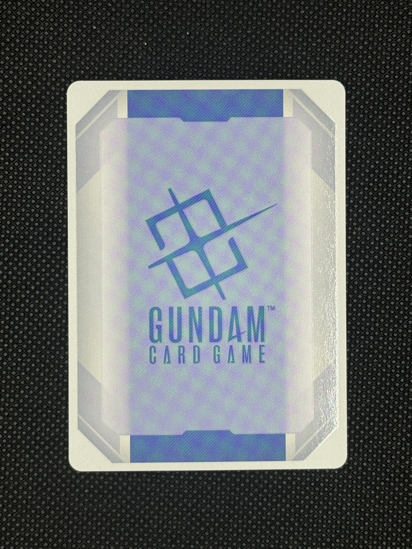 Gundam card game packaging on a textured black background