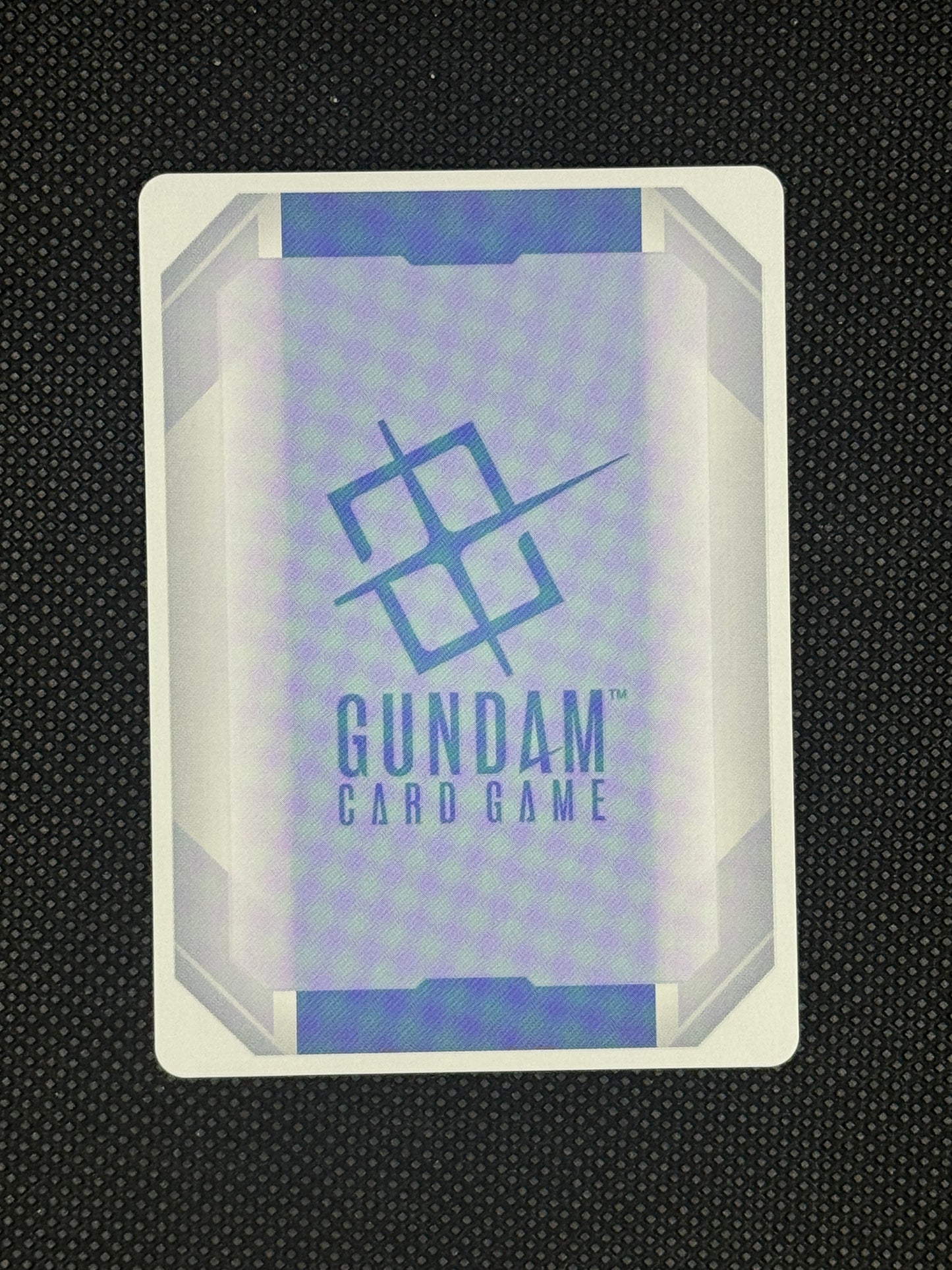Gundam card game packaging on a textured black background