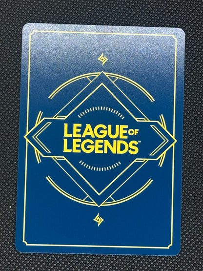 League of Legends card with blue background and yellow text on a textured black surface
