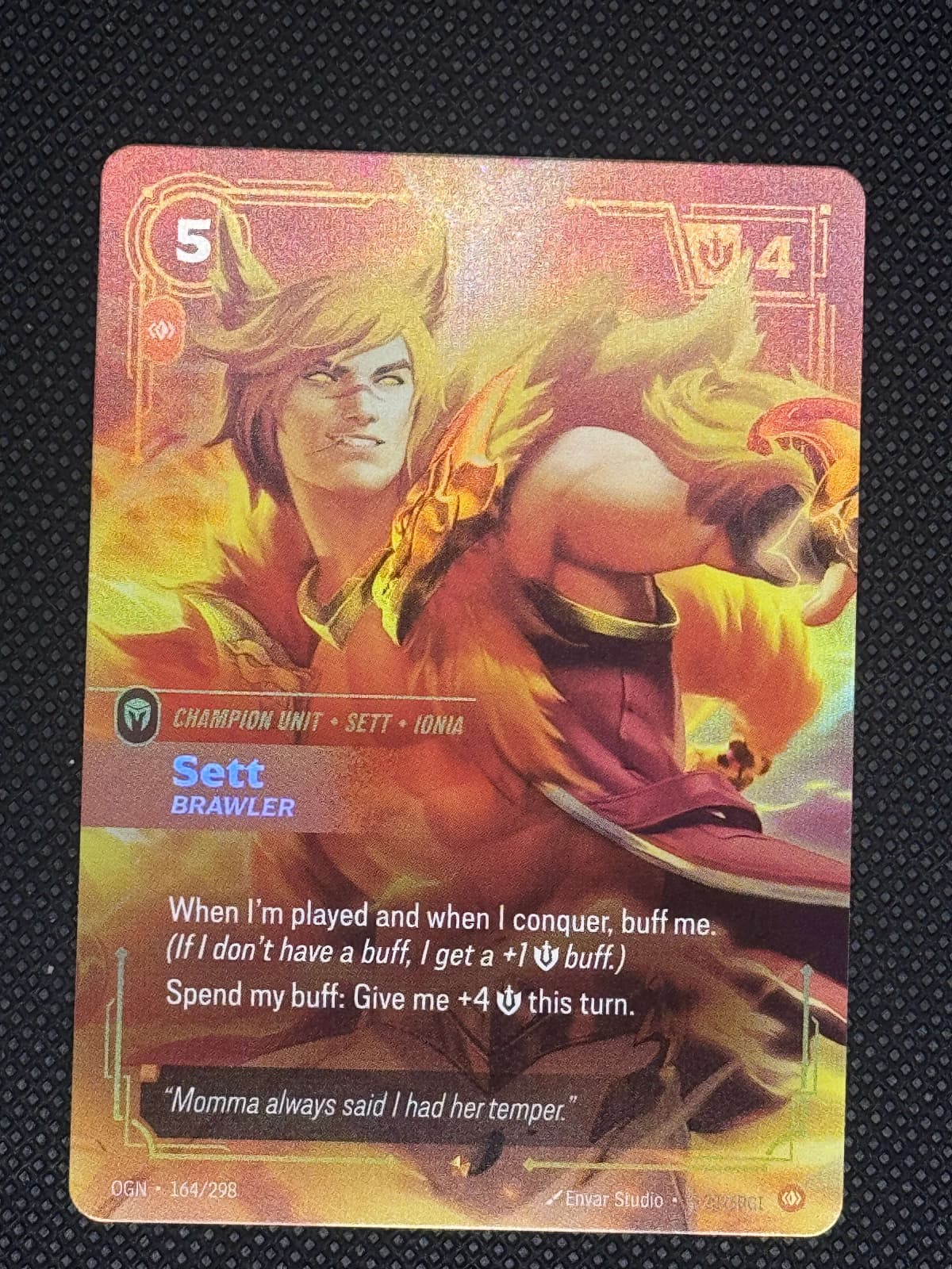 Card with a fantasy design featuring a character and creature on a dark textured background