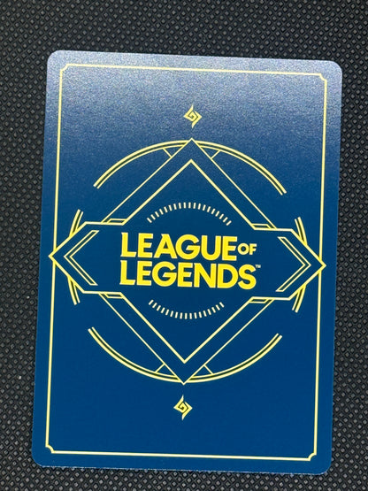 League of Legends card with blue background and yellow text on a textured black surface