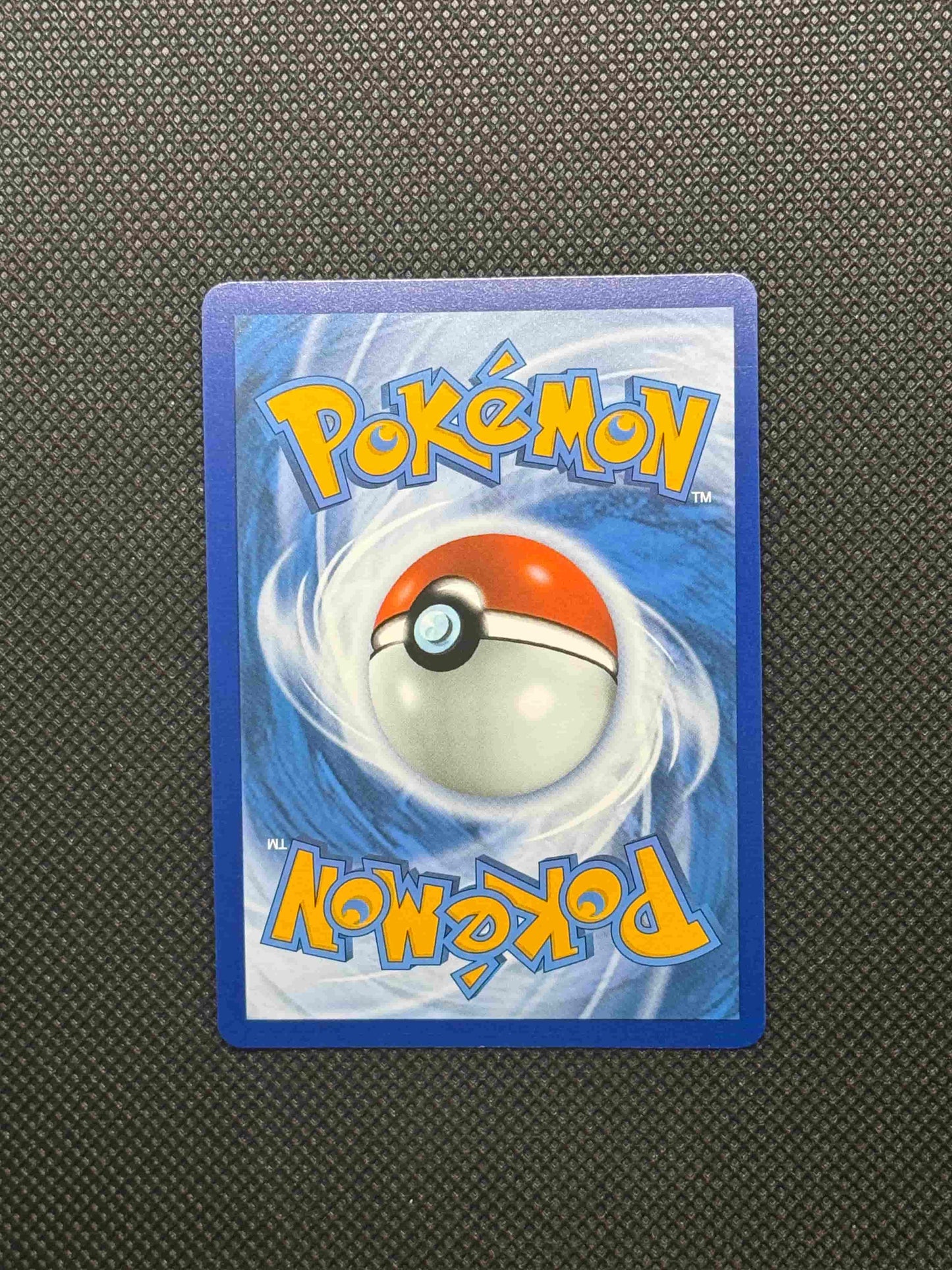 pokemon logo with blue, yellow, and red. With a pokeball and swirls in the back.