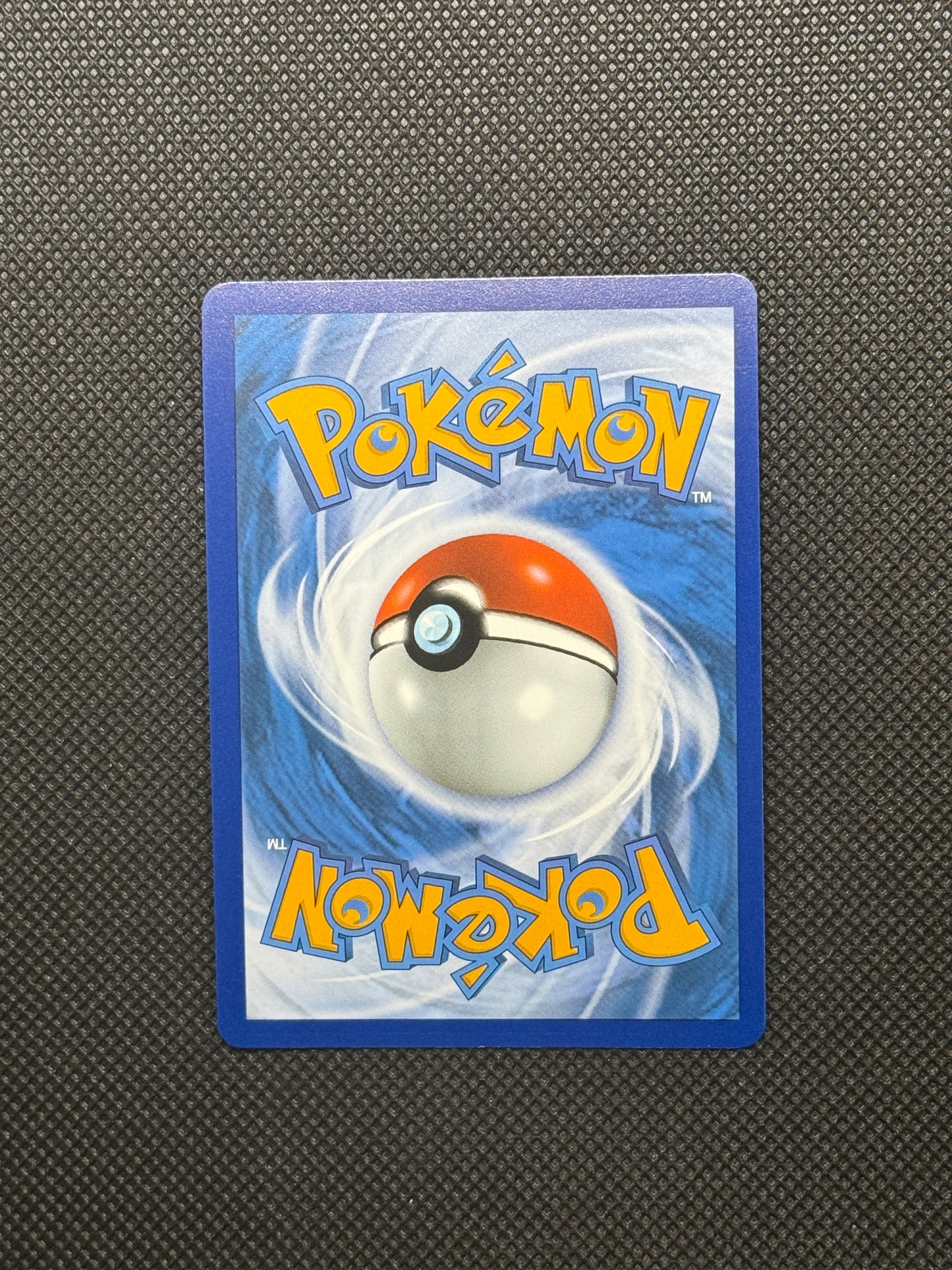 pokemon logo with blue, yellow, and red. With a pokeball and swirls in the back.