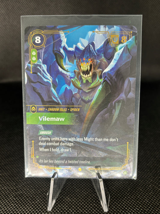 A holographic collectible trading card featuring the character Vilemaw, displayed on a clear acrylic stand against a dark textured background.
