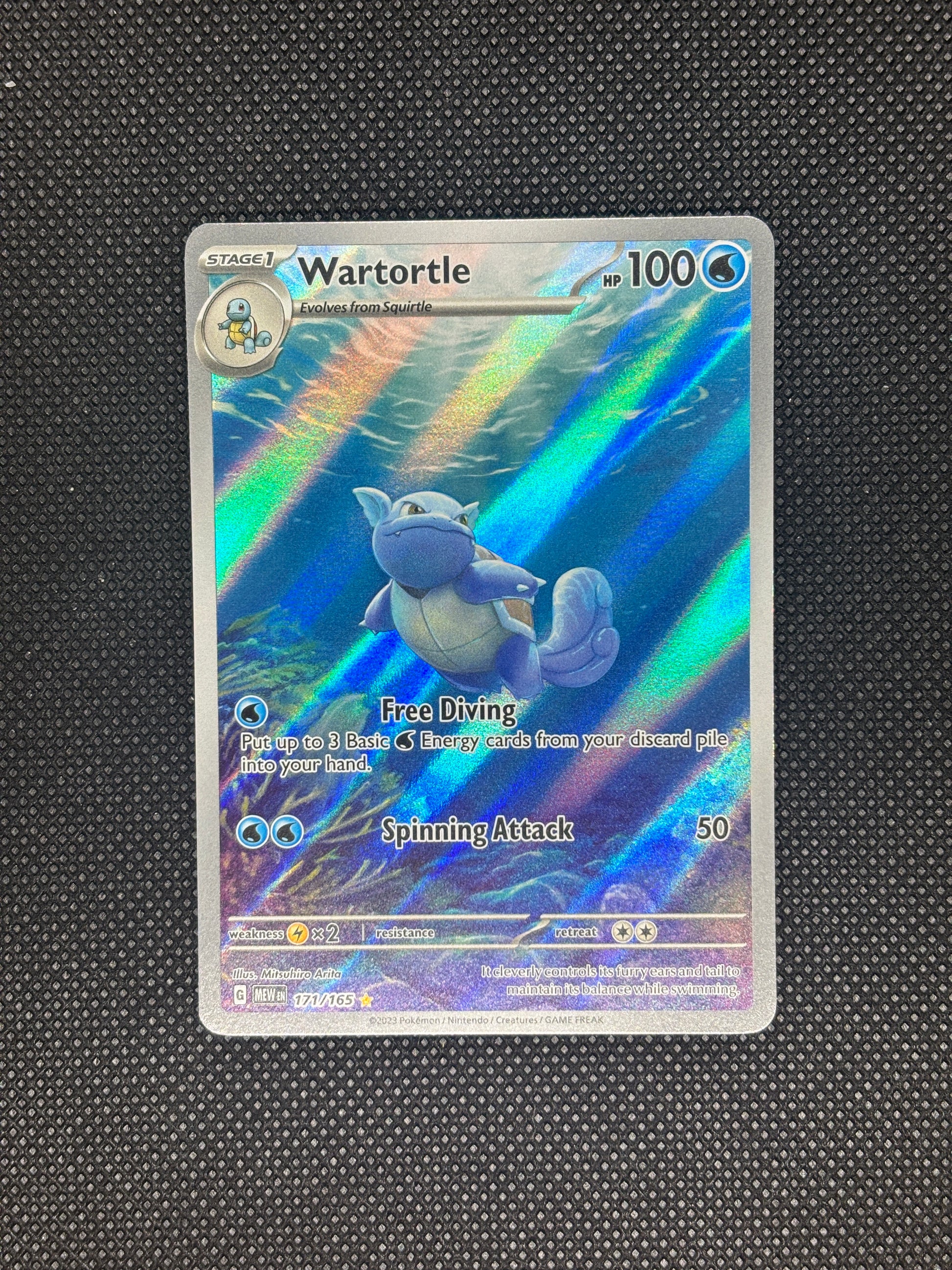 Wartortle swimming in the sea next to a coral reef as rays of sunshine come through the water.