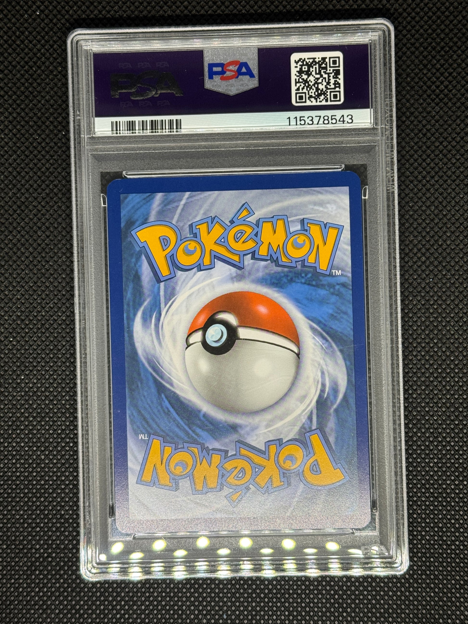 Pokémon trading card in a protective case with PSA logo, QR code, and Barcode.